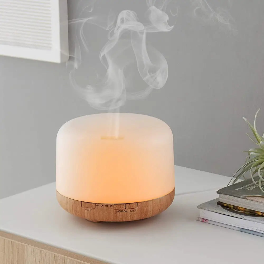 5 in1 orange light with steam aroma diffuser sitting on table.