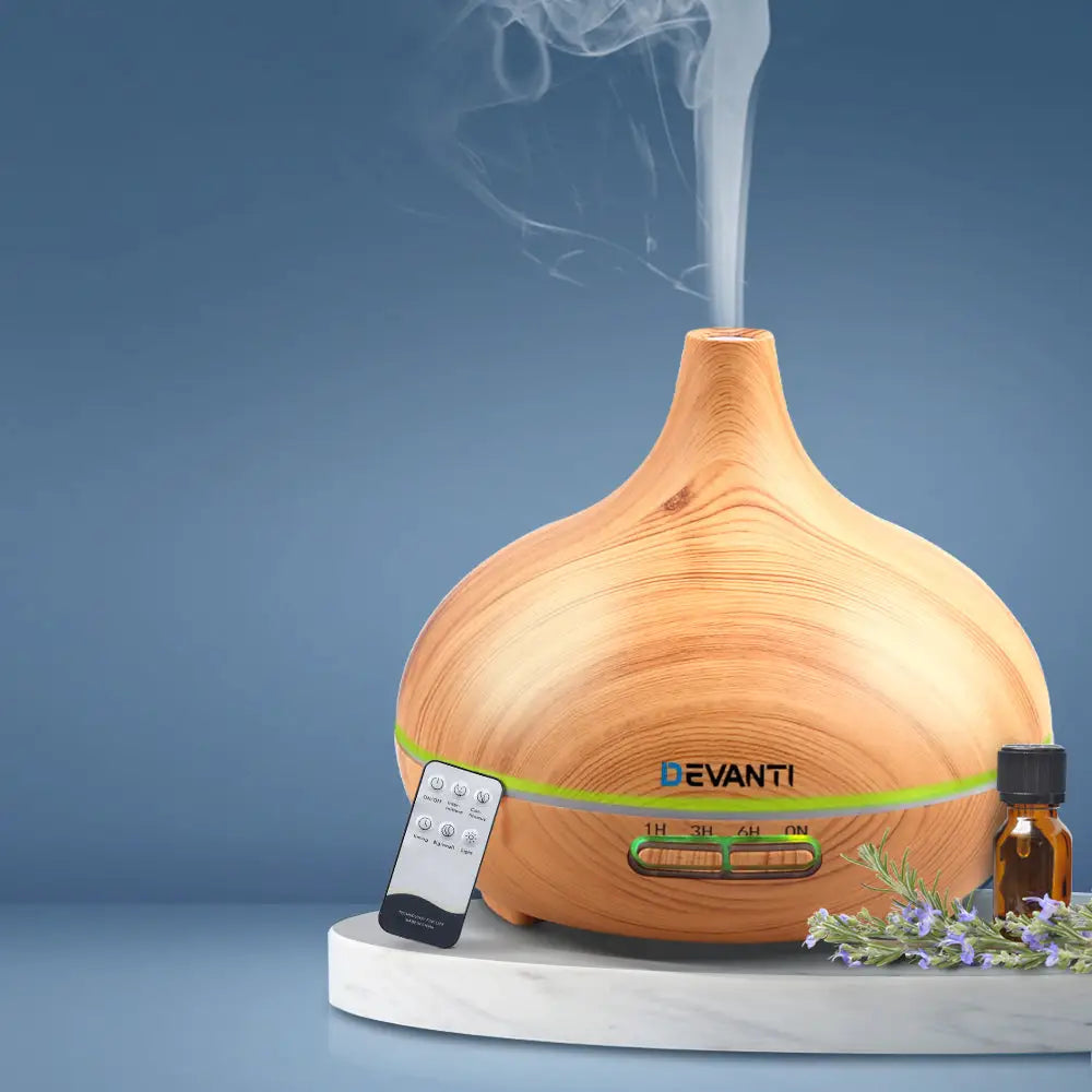 zen shaped vase devanti 4 in 1 diffuser light wood colour with steam on blue background.