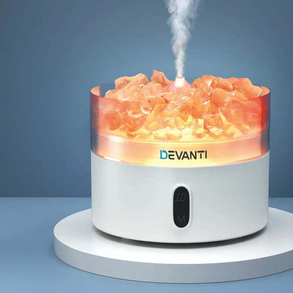 Devanti Crystal Air Humidifier with steam sitting on white marble with blue background.