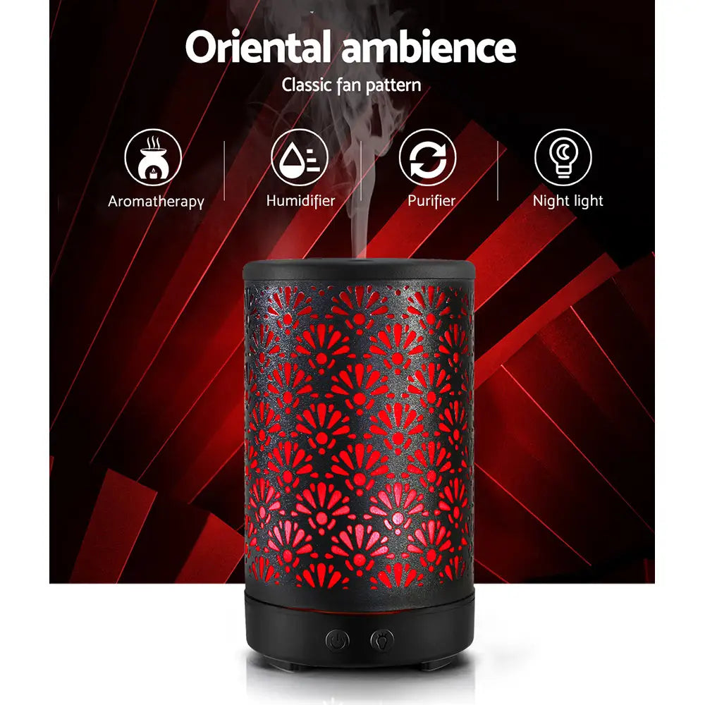 black decorative metal devanti diffuser with red led light on in night setting.