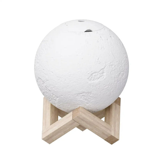 white round Moon Lamp with craters on timber stand Diffuser on white background.