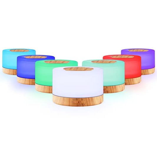 7 different led light colours of the devanti round neon night light diffusers with light wood bases on white background.