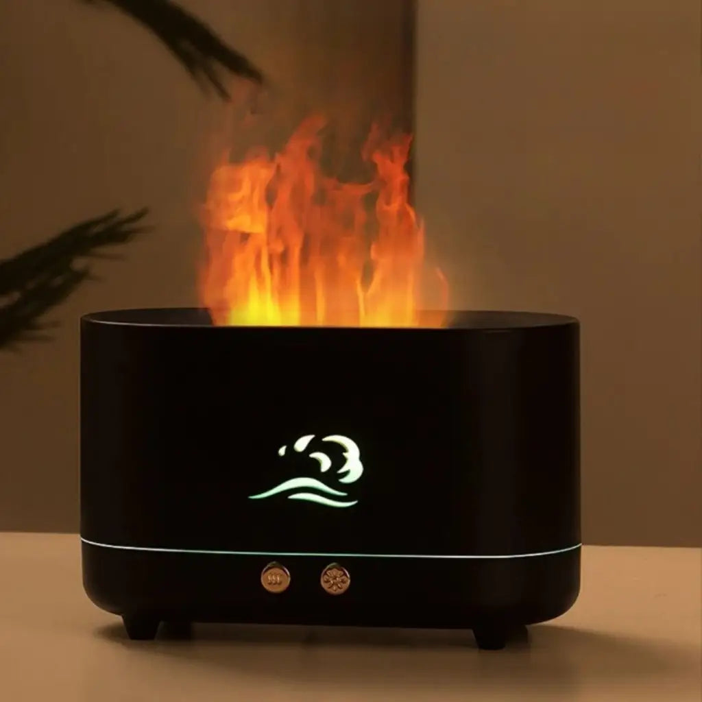 matt black humidifier with flame coming out of top sitting on timber table with tan background.