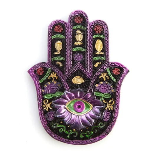 Hamsa shaped incense burner with metallic purple  green and gold details on white background