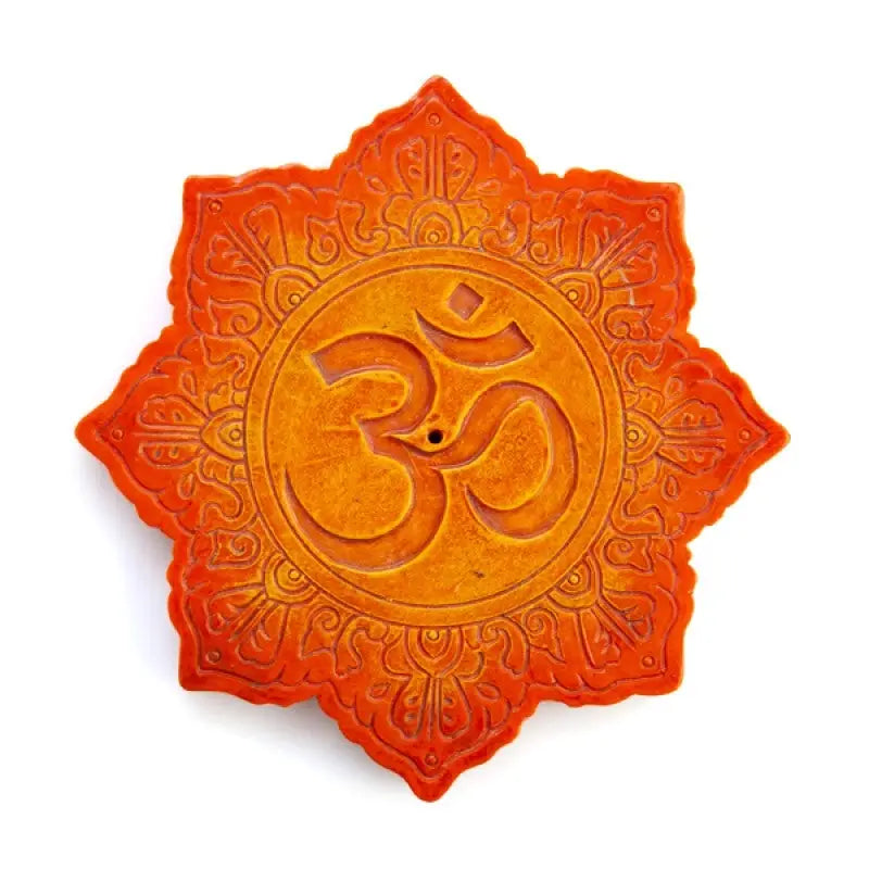 Lotus-shaped incense burner featuring spiritual symbol 'om' surrounded by intricate carved details
With vibrant orange colouring with stone texture on white background

